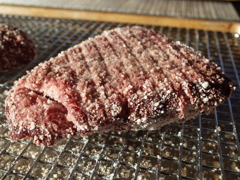 A single Koji rubbed sirloin steak on rack after 48 hours aging in the refrigerator.